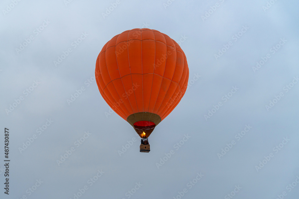 bright orange balloon flying in the blue sky bright orange balloon flying in the blue sky