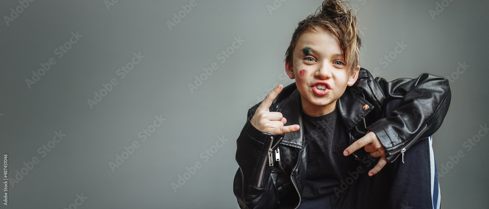 an emotional cheerful boy in a black rocker leather jacket, with a mohawk on his head, with a bruise and an abrasion on his face, a bully, a brawler