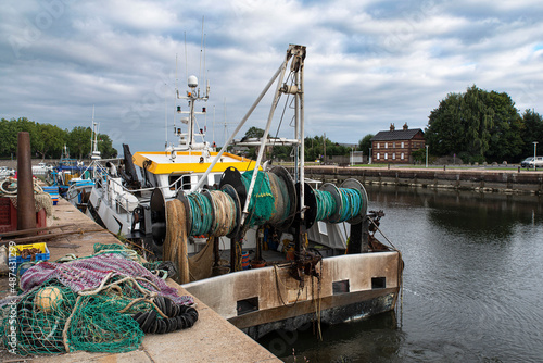 Fotografi A fishing boat with its nets in a port in Normandy, France