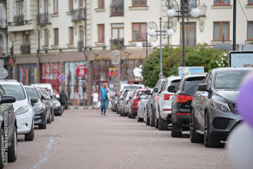 Cars parked in line on city street side. Urban traffic concept photo