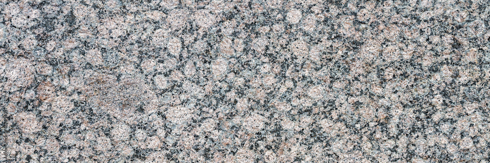 Granite texture. Natural gray granite with a grainy pattern. Stone background. Solid rough surface of rock. Durable construction and decoration material. Close-up. Granite texture. Natural gray granite with a grainy pattern. Stone background. Solid rough surface of rock. Durable construction and decoration material. Close-up.