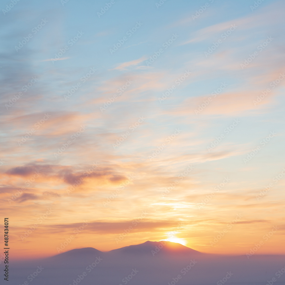 Sunset over the tundra and snow-capped mountains. Winter arctic landscape. Cold winter weather. Frosty fog over the winter tundra. The nature of Chukotka and polar Siberia. Far North of Russia, Arctic