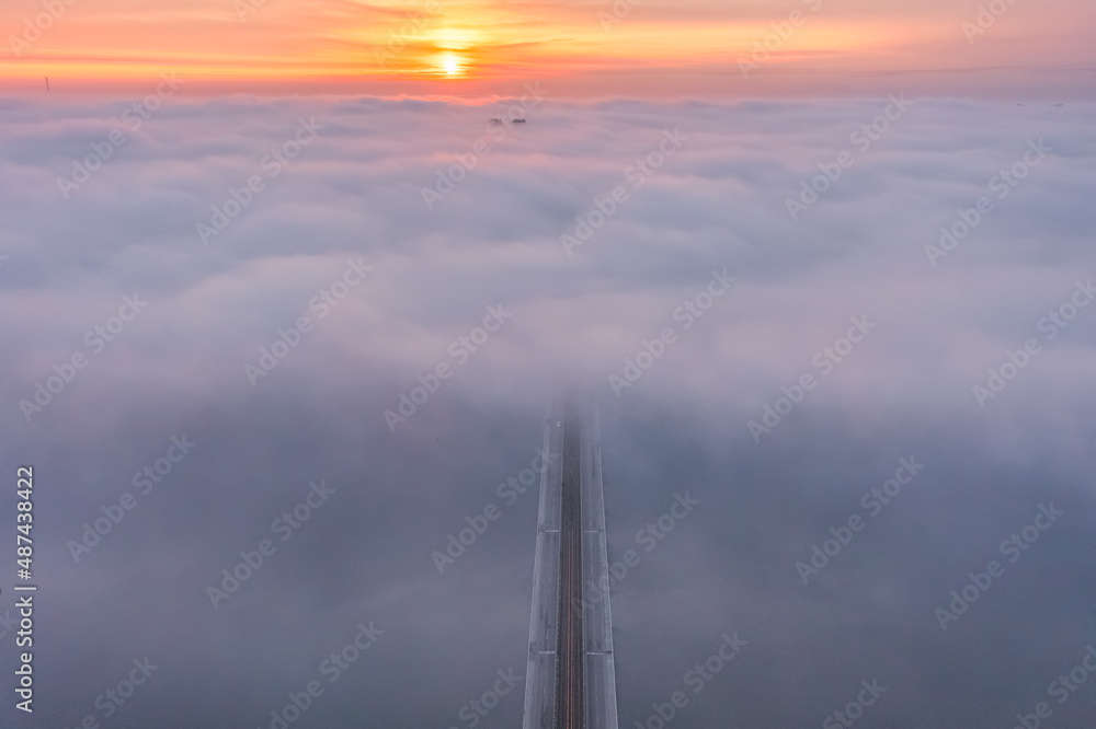 Aerial drone view, Patona bridge in Kiev city, Ukraine, shrouded in thick pink lilac fog.Beautiful scenery, relaxing state