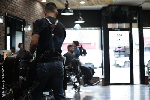 barber giving haircut in barbershop