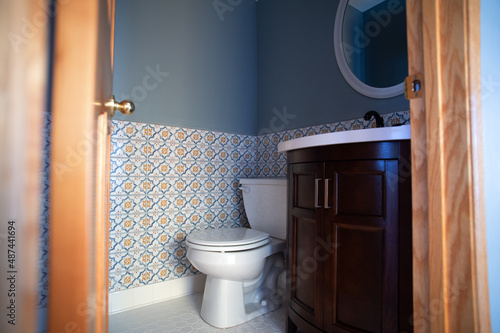 A tiled bathroom view, including a toilet and a vanity.