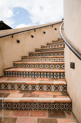 Terracotta tiled curving staircase with Mexican tile facings