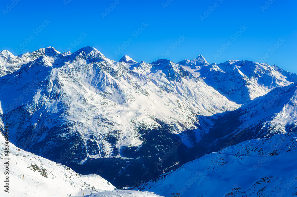 Obraz premium Austrian Alps covered with snow during sunny winter day.