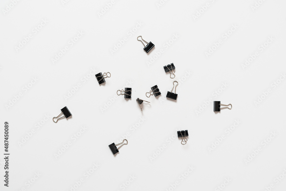 some metal paper binder clips flat lay, minimalistic isolated concept some metal paper binder clips flat lay, minimalistic isolated concept