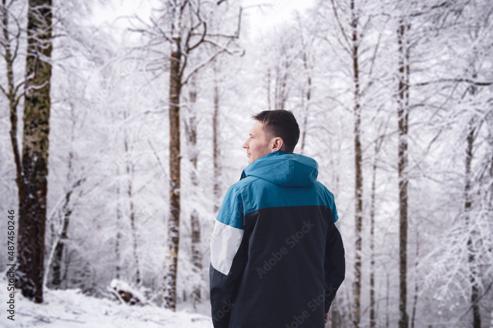 young male guy wearing warm winter season jacket on a cold day young male guy wearing warm winter season jacket on a cold day