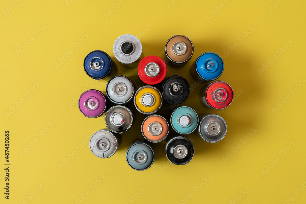 set of some spray paint cans of different colors flat lay set of some spray paint cans of different colors flat lay