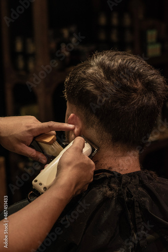 Man getting haircut at barbershop. photo