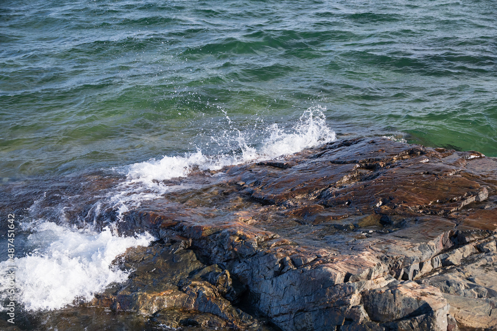 Water splashing over large rock Water splashing over large rock