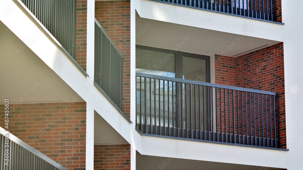 Fototapeta premium Abstract architecture, fragment of modern urban geometry,. Modern apartment building on a sunny day with a blue sky,. European residential apartment buildings.