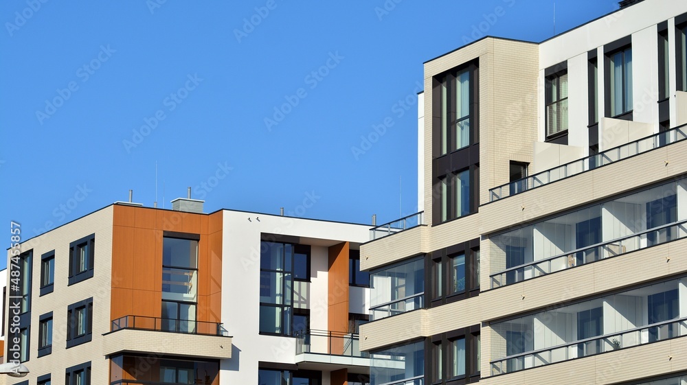 Obraz premium Abstract architecture, fragment of modern urban geometry,. Modern apartment building on a sunny day with a blue sky,. European residential apartment buildings.