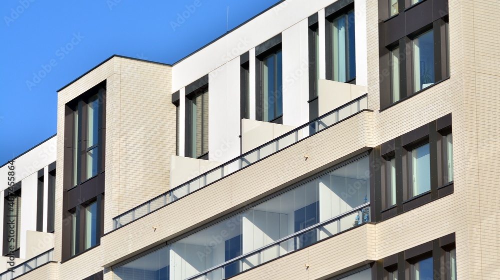 Abstract architecture, fragment of modern urban geometry,. Modern apartment building on a sunny day with a blue sky,. European residential apartment buildings. Abstract architecture, fragment of modern urban geometry,. Modern apartment building on a sunny day with a blue sky,. European residential apartment buildings.