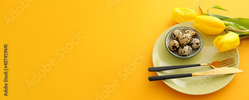 Beautiful table setting for Easter celebration on orange background with space for text