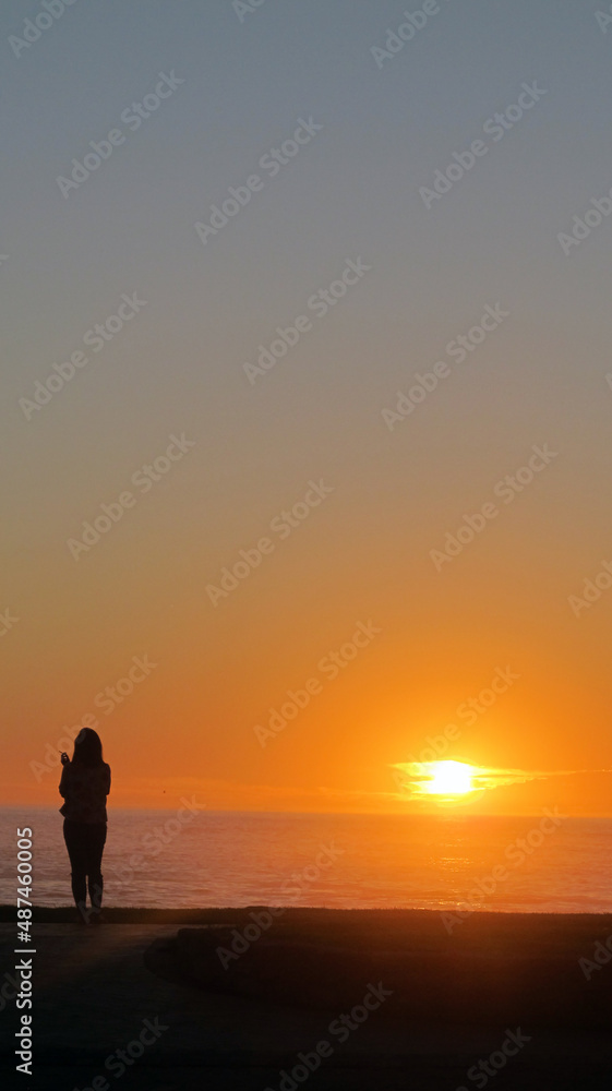 silhouette of a person on a sunset beach