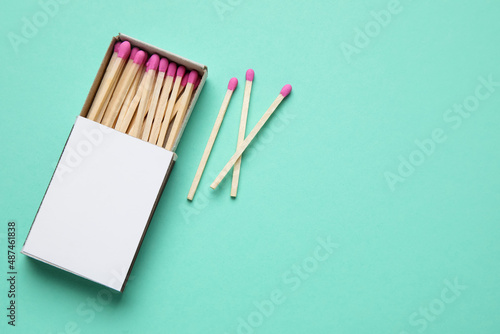 Box with new matchsticks on color background