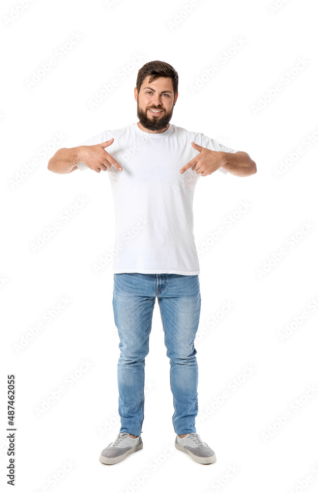 Handsome man pointing at t-shirt on white background Handsome man pointing at t-shirt on white background