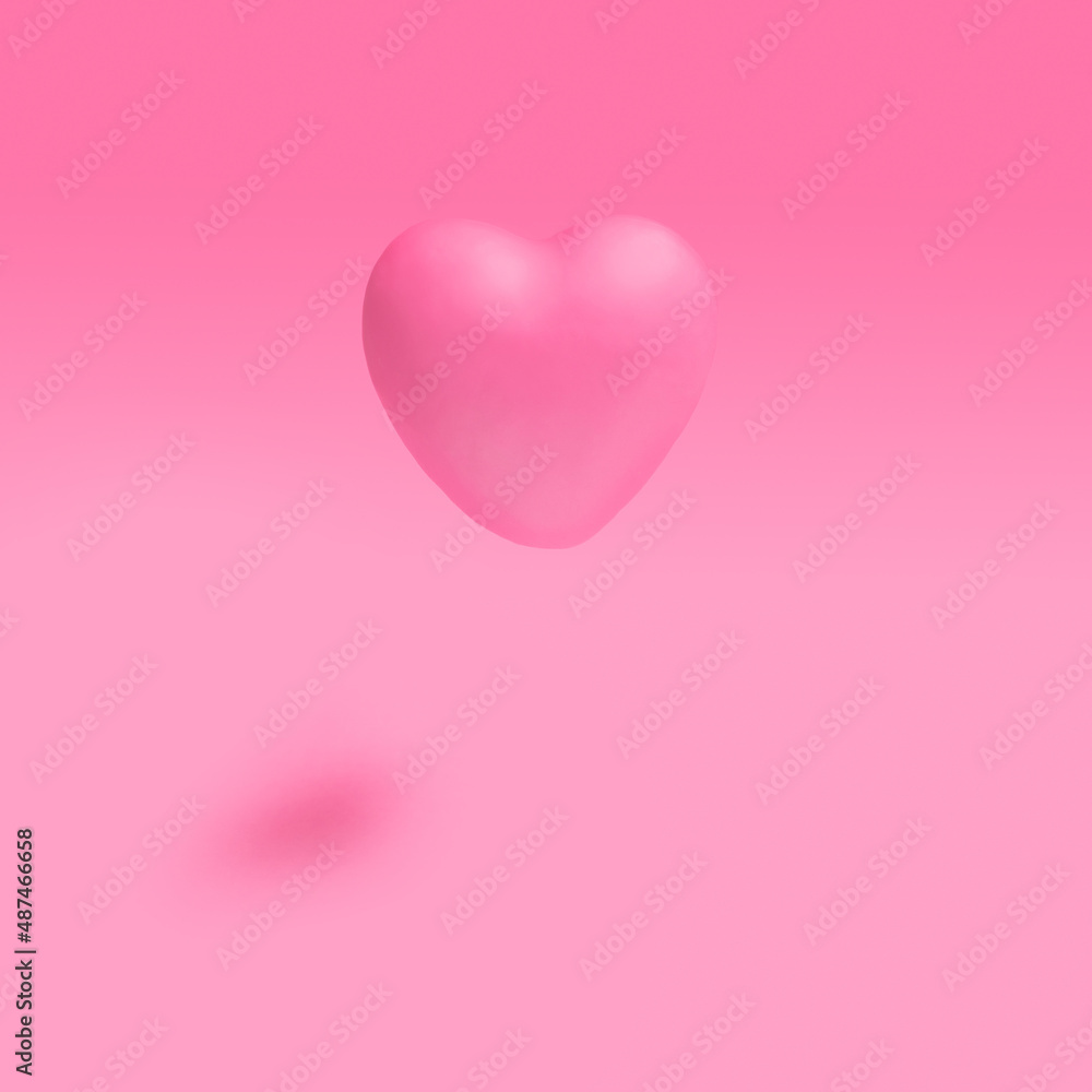 A soft pink heart on gradient  light pink shade background with sunny shadow.