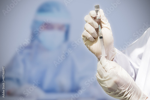 Doctor's hand holding a syringe, Concept fight against virus covid-19 coronavirus