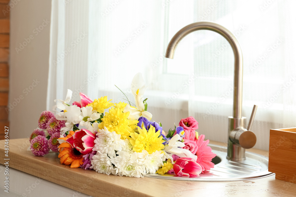 Bouquet of beautiful flowers in sink near window Stock Photo Adobe Stock