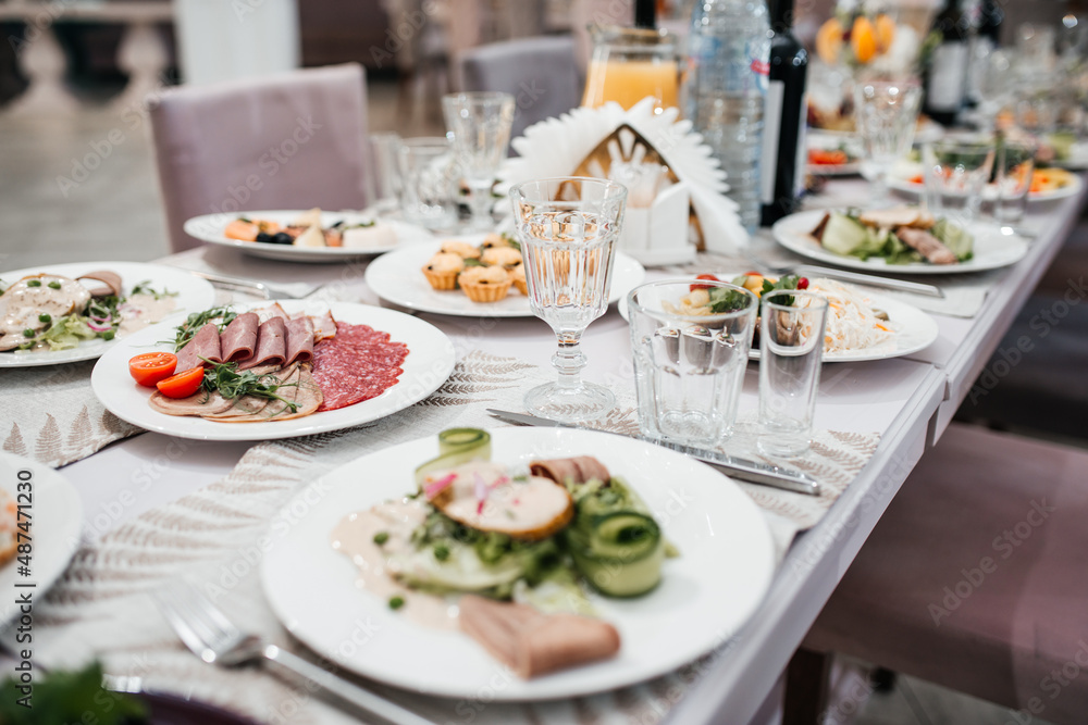 beautifully set table at a wedding banquet with delicious food and alcohol beautifully set table at a wedding banquet with delicious food and alcohol