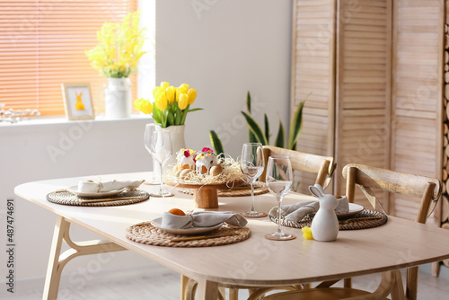 Festive dinnerware on table served for Easter celebration in room