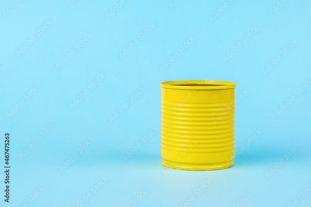 A yellow tin can on a bright blue background. Universal container. A yellow tin can on a bright blue background. Universal container.