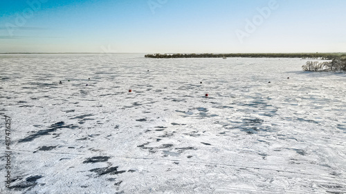 Frozen lake with ice fishing shanties
