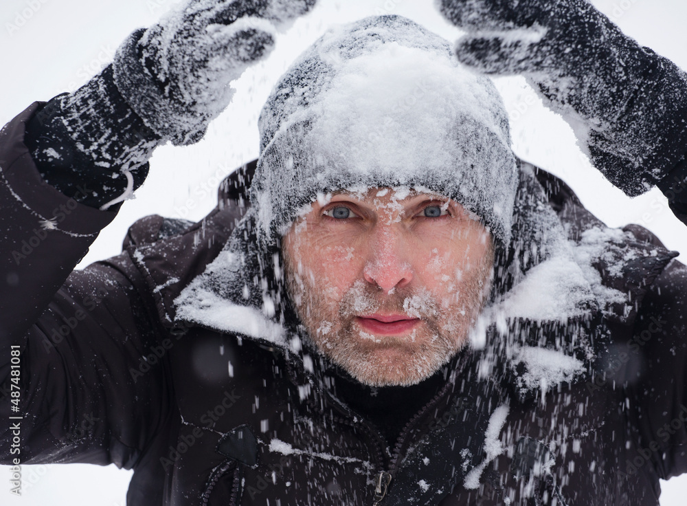 Portrait of a handsome man covered in snow. Portrait of a handsome man covered in snow.