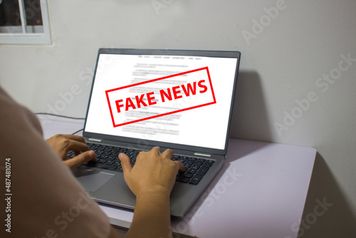 Laptop computer showing its screen with Fake news.