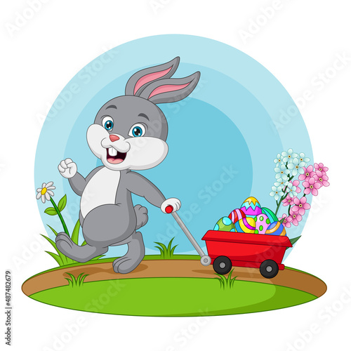 Cute little bunny carrying a cart with easter eggs