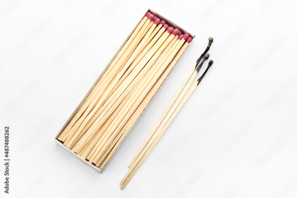 Whole and burnt fireplace matches on white background. Burnout concept Whole and burnt fireplace matches on white background. Burnout concept