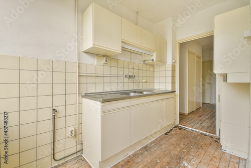 an old style kitchen room with white tiled walls
