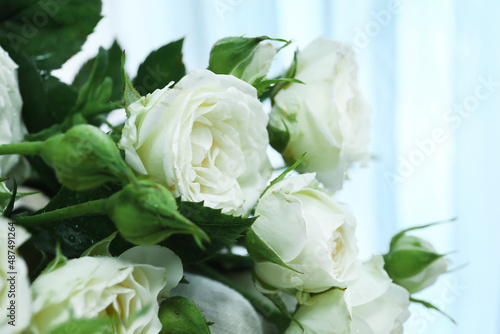 Bouquet of beautiful fresh roses in room  closeup