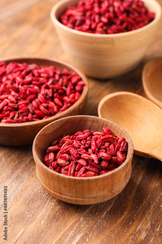 Bowls with dried barberries on wooden background Bowls with dried barberries on wooden background