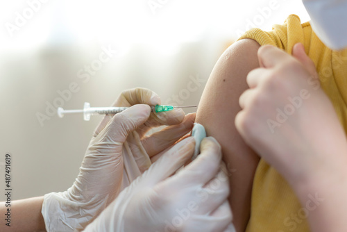 Close up of Young asian girl getting vaccinated or inoculation or Coronavirus Vaccine Injection. photo