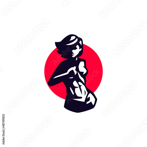 A woman with a short haircut in a sports jersey demonstrates the cubes of the abdominal press. A woman pulls her shirt up.