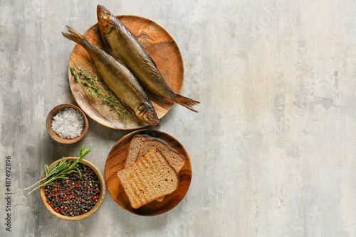 Photography Plate with smoked herring fishes and bread on grey background