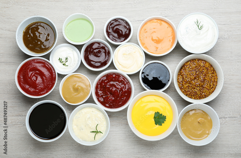 Many different sauces on white wooden table, flat lay Many different sauces on white wooden table, flat lay