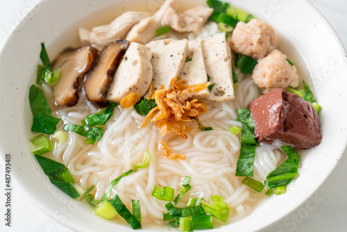 Vietnamese Rice Noodles Soup with Vietnamese Sausage served vegetables and crispy onion