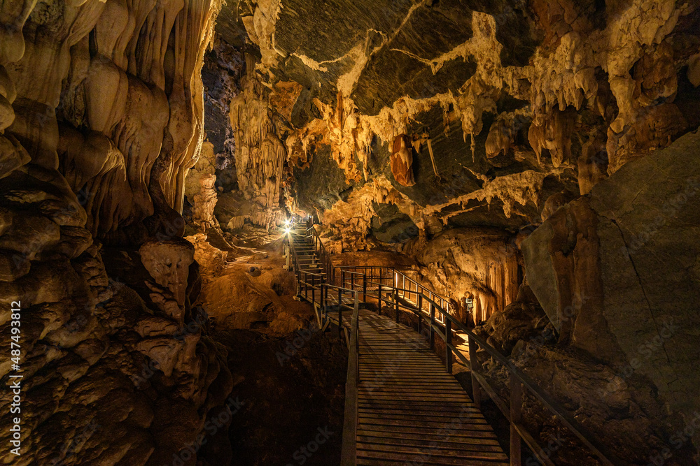 The wooden walking path through stalactite and stalagmite in Phu Pha Petch cave at Thailand

