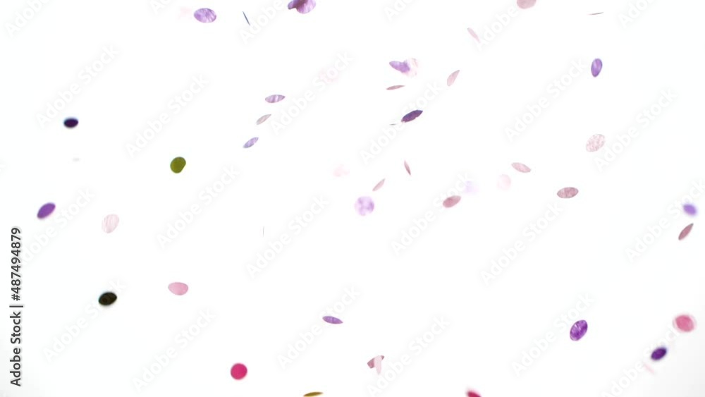 Pink and purple holiday confetti particles isolated on white background falling Pink and purple holiday confetti particles isolated on white background falling