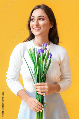 Woman holding iris flowers ...