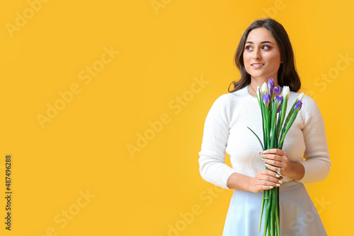 Woman holding iris flowers ...