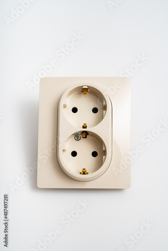Double socket insulated on a white background. 2 sockets connected by one monolithic housing. The socket has two plug connectors, but is installed in one standard socket.