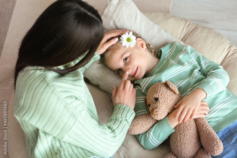 Young mother touching her little daughter's nose at home Young mother touching her little daughter's nose at home