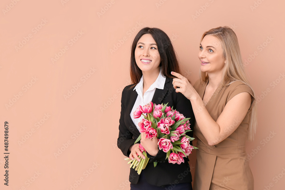 Beautiful women with bouquet of flowers on color background. International Women's Day celebration Beautiful women with bouquet of flowers on color background. International Women's Day celebration