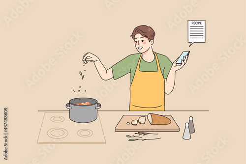 Smiling man cooking soup at home kitchen follow recipe on smartphone screen. Happy male chef prepare delicious food for dinner with online instruction on cellphone. Vector illustration. 